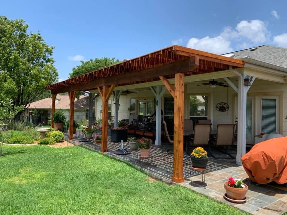 Cedar pergola extending a covered porch over a flagstone patio in the Austin area
