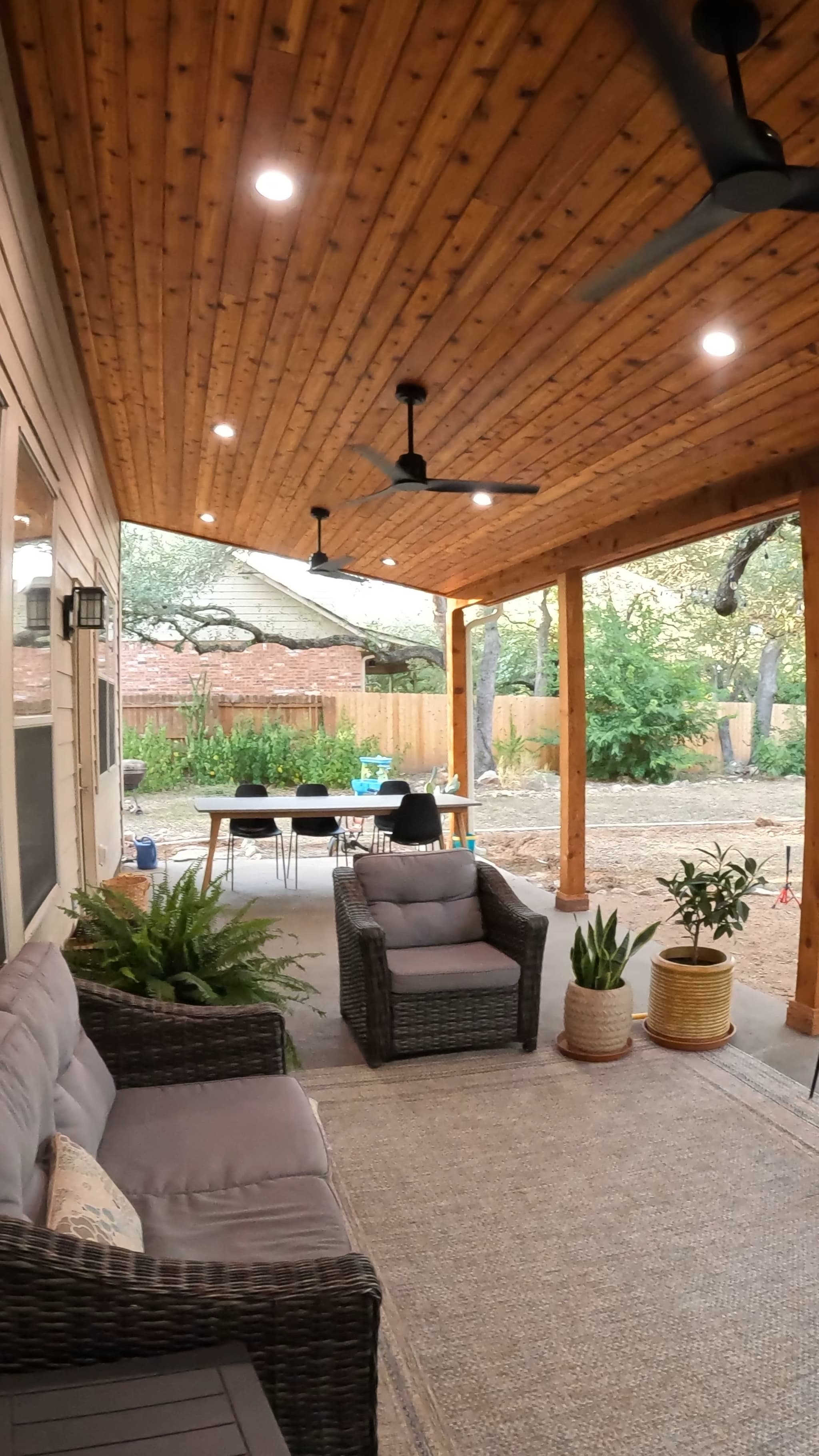 Covered patio with tongue-and-groove cedar ceiling, recessed lights, and three ceiling fans in Central Texas